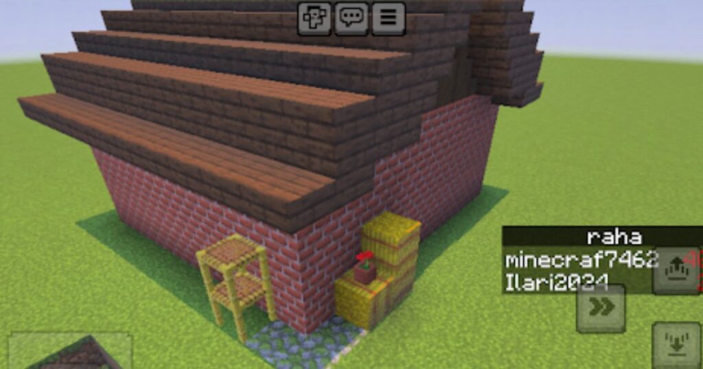 マインクラフトの画面でレンガの家を建築している様子